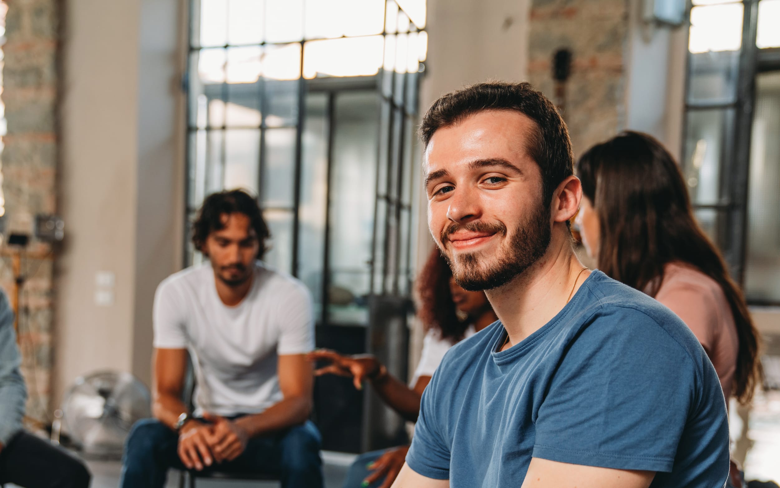 Man smiling in support group